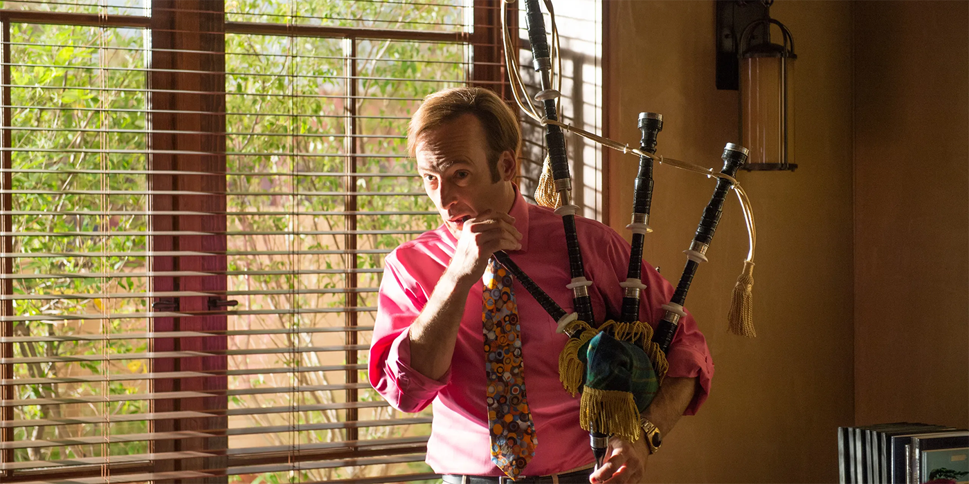 Bob Odenkirk as Jimmy in a pink suit playing the bagpipe