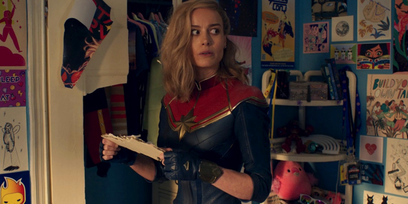 Brie Larson's Captain Marvel looks around at pictures of herself in Kamala's room in The Marvels.