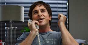 Christian Bale as Michael Burry on the phone looking excited in The Big Short