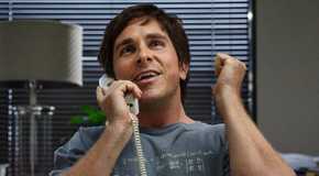 Christian Bale as Michael Burry on the phone looking excited in The Big Short