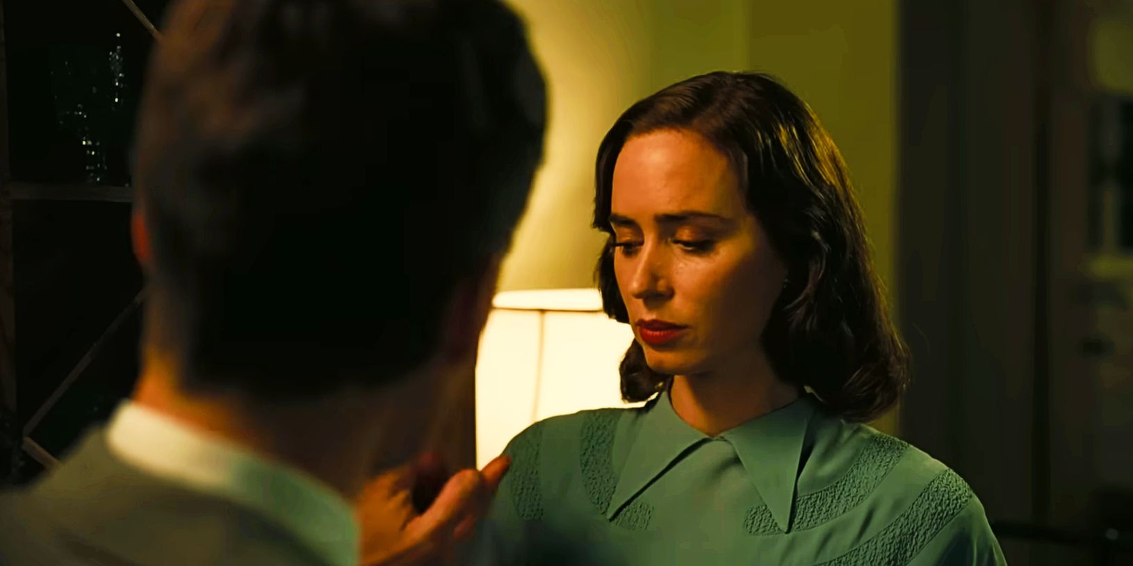 Cillian Murphy and Emily Blunt touch hands in Oppenheimer