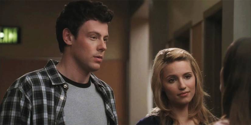 Cory Monteith and Dianna Agron stand together in the hallway in Glee