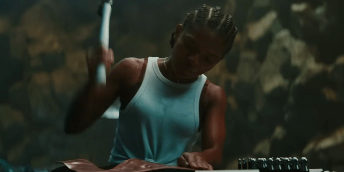Dominique Thorne as Riri Williams Hammering Metal In Wakandan Workshop In Black Panther: Wakanda Forever