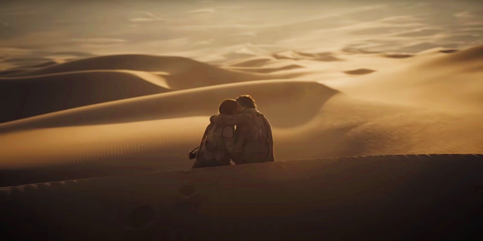 Chani, played by Zendaya, kisses Paul Atreides, played by Timothée Chalamet, in Dune: Part Two.