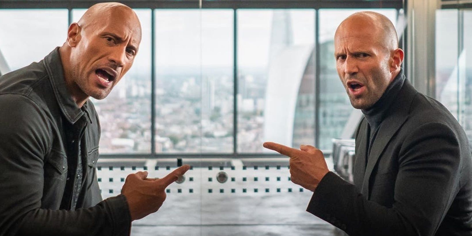Dwayne Johnson and Jason Statham pointing at each other in Hobbs and Shaw