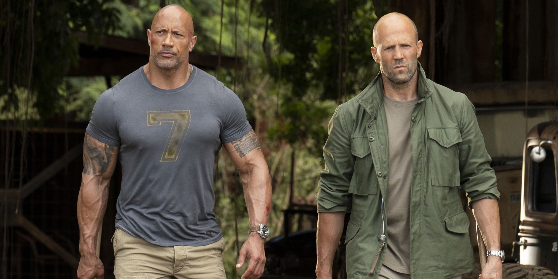 Dwayne Johnson and Jason Statham walking with weapons in Hobbs and Shaw