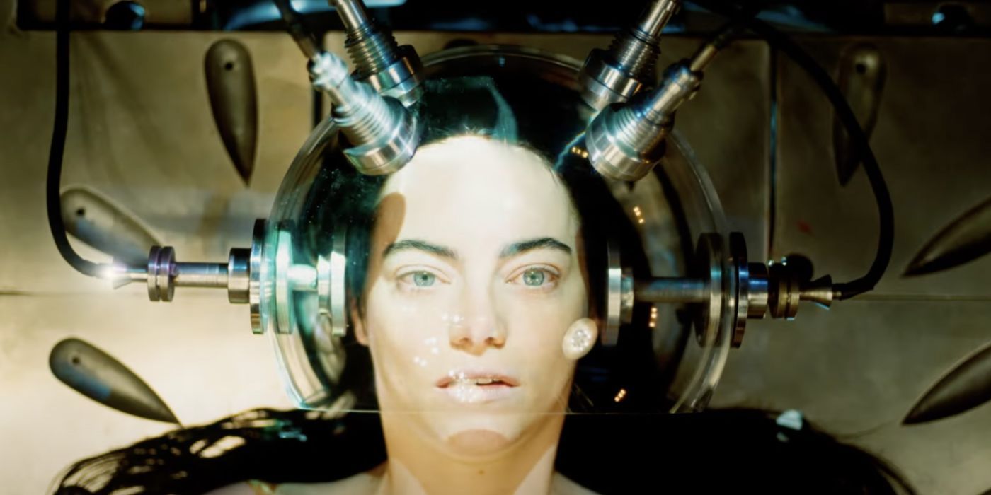 Emma Stone in Poor Things with her head in a machine.