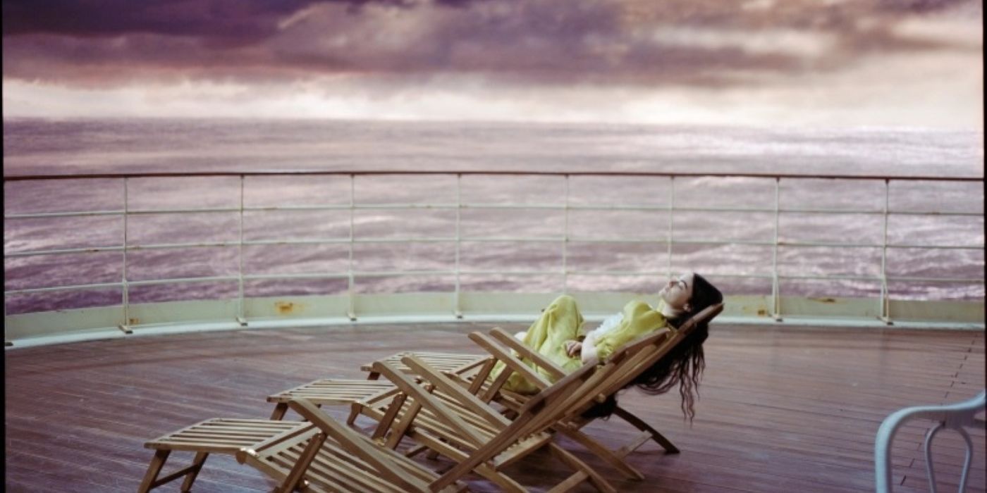 Emma Stone lounging on a boat deck in Poor Things.