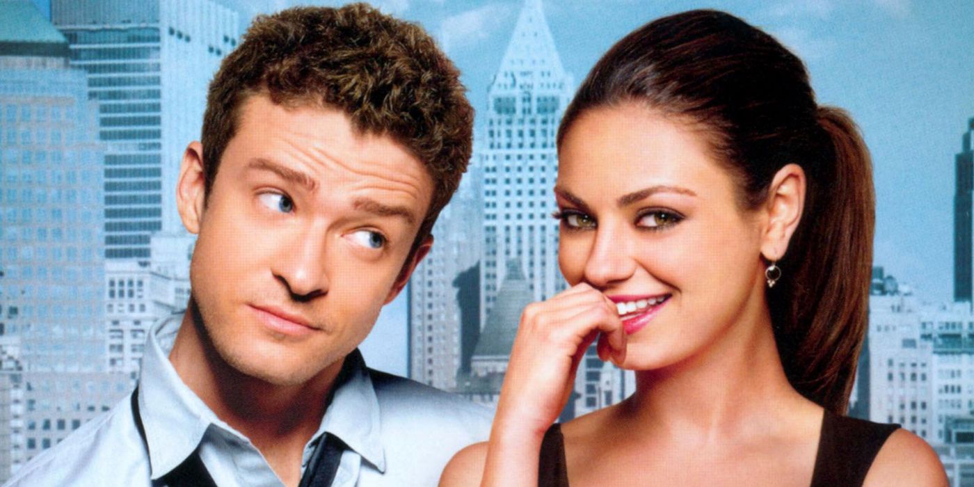 Justin Timberlake looks at Mila Kunis who is biting her fingernail and smiling.