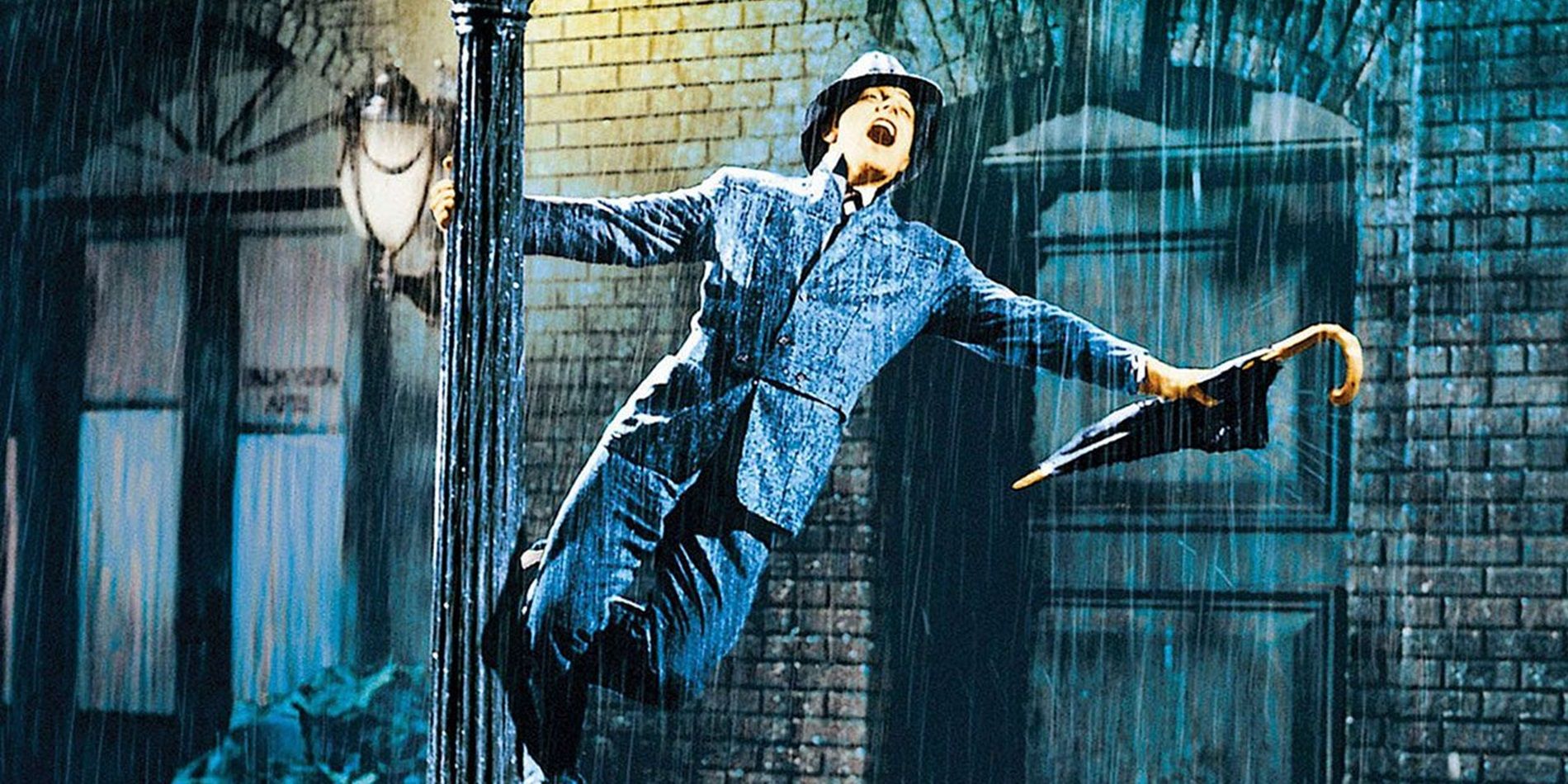 Gene Kelly as Don hanging from a lamppost in Singin' in the Rain