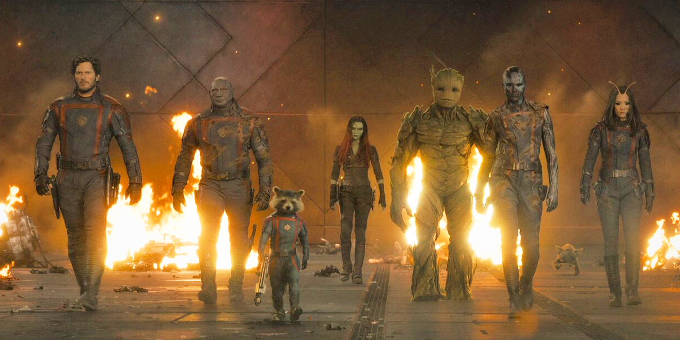 The Guardians walking towards the camera with fire behind them in a scene from Guardians of the Galaxy Vol. 3.