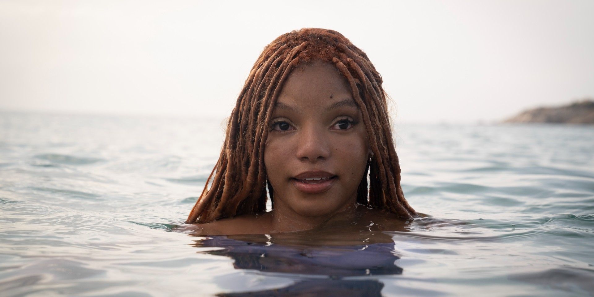 Halle Bailey as Ariel emerging from the water in The Little Mermaid