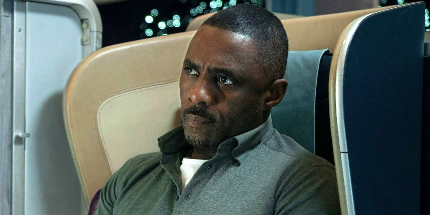 Idris Elba sitting in his seat staring in Hijack