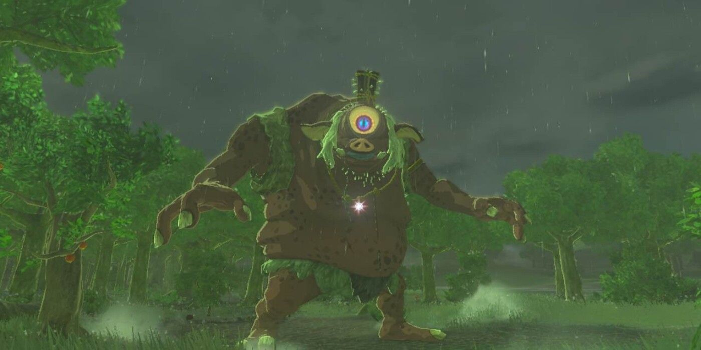 A red Hinox spots the player on a rainy day in Hyrule, staring at the camera in Zelda: Tears of the Kingdom