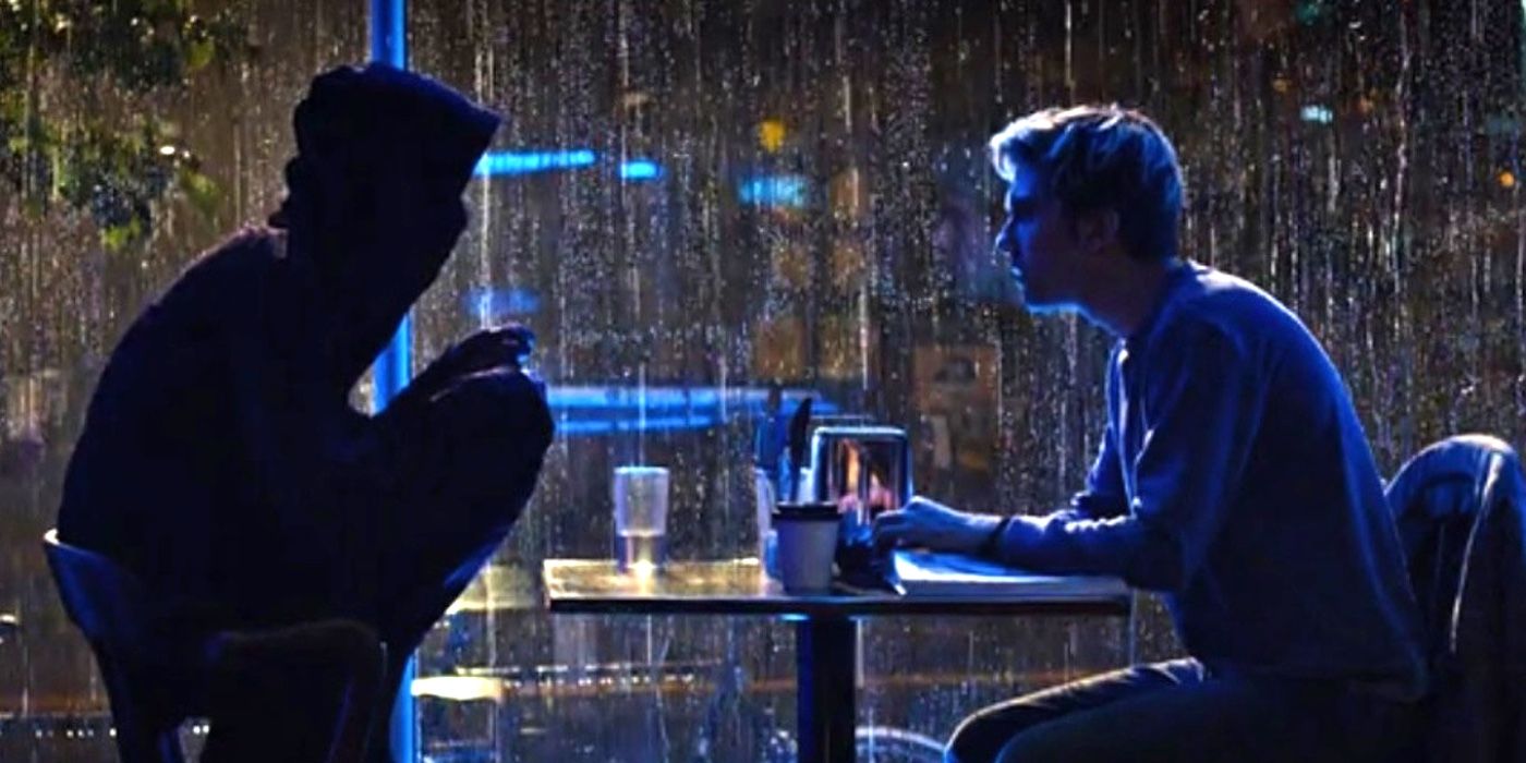 Lakeith Stanfield as L and Nat Wolff as Light Yagami sitting at a table together in a scene from Netflix's Death Note.