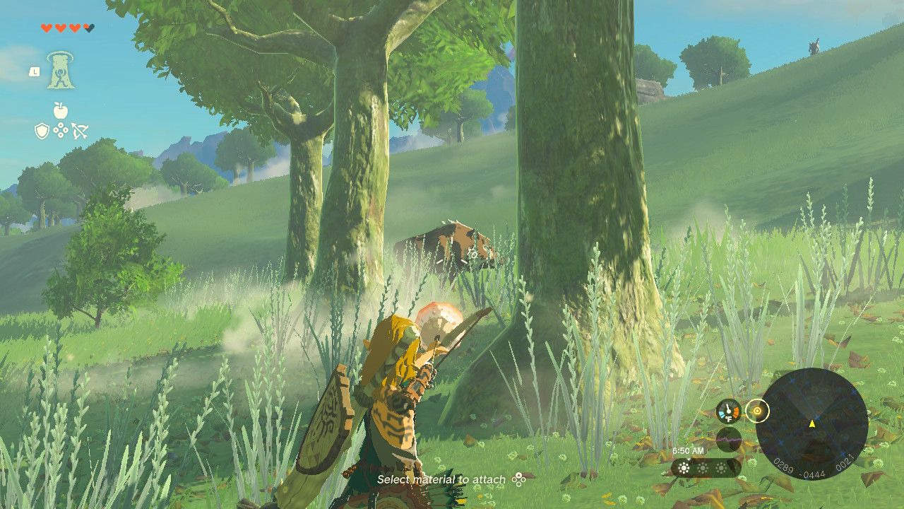 Link holding an arrow with a keese eyeball on it aimed at a target.