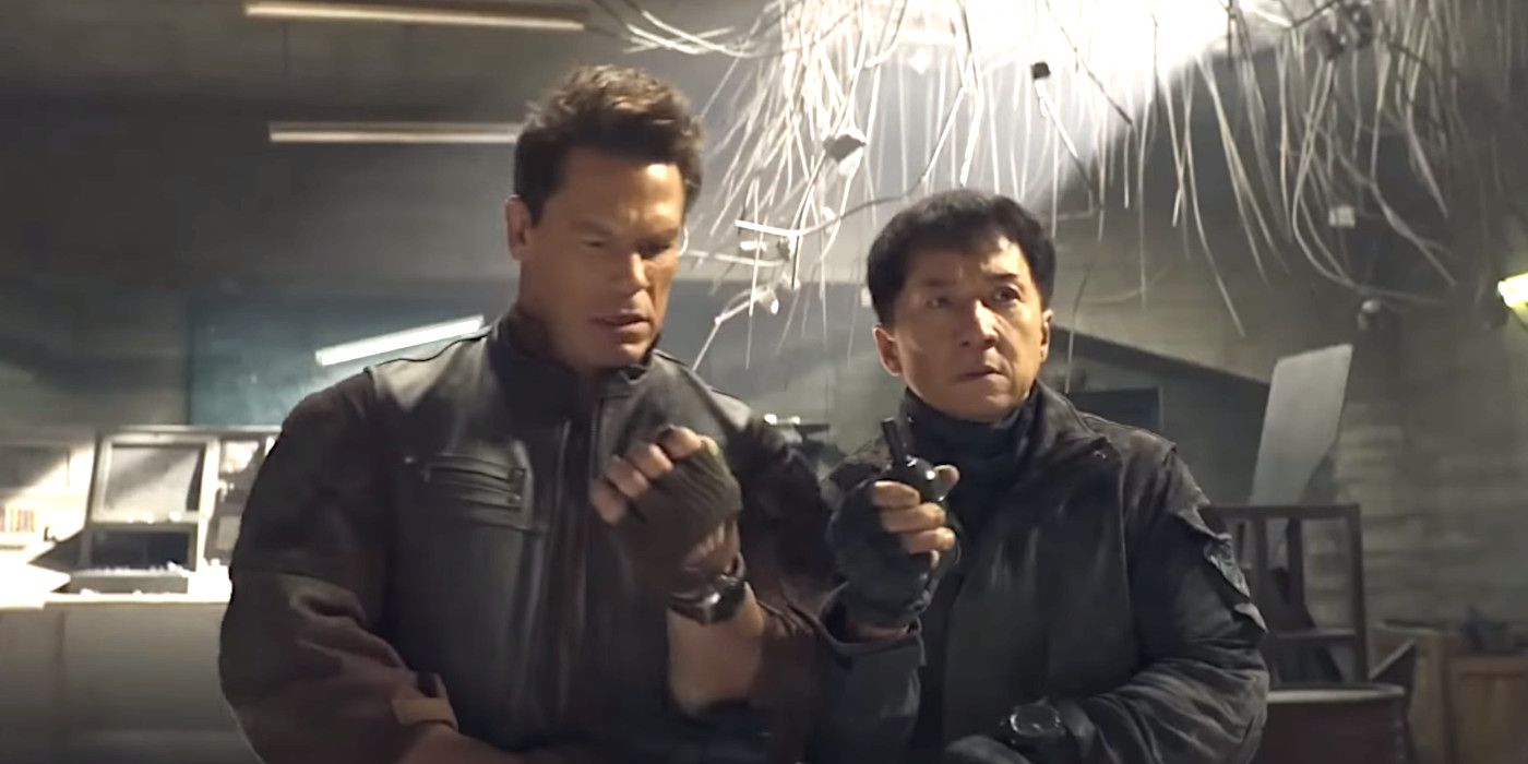 John Cena e Jackie Chan em Hidden Strike, lado a lado em uma sala parecida com um bunker, segurando granadas e parecendo preocupados