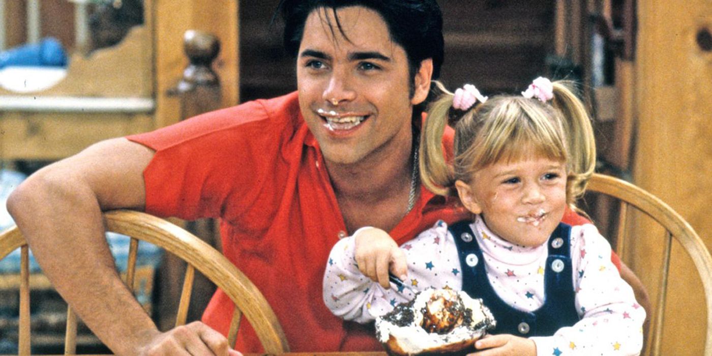 John Stamos and one of the Olsen twins as Jesse Katsopolis and Michelle Tanner in Full House