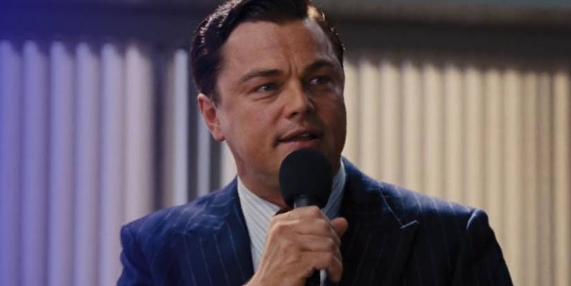 Jordan Belfort (Leonardo DiCaprio) holding a microphone in The Wolf of Wall Street