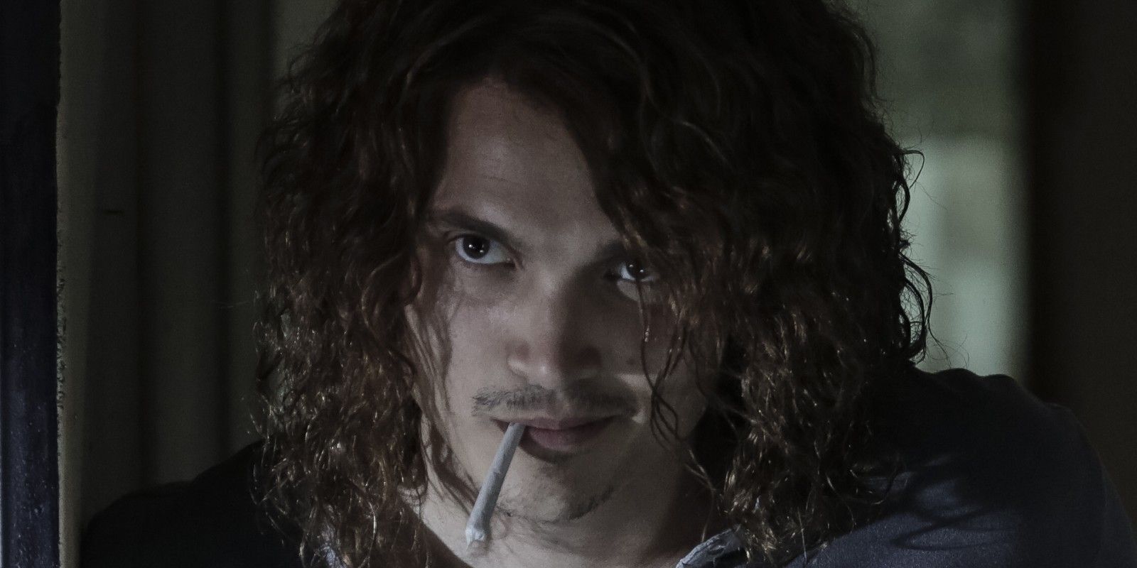 Karl Glusman as Joe B with a cigarette in his month