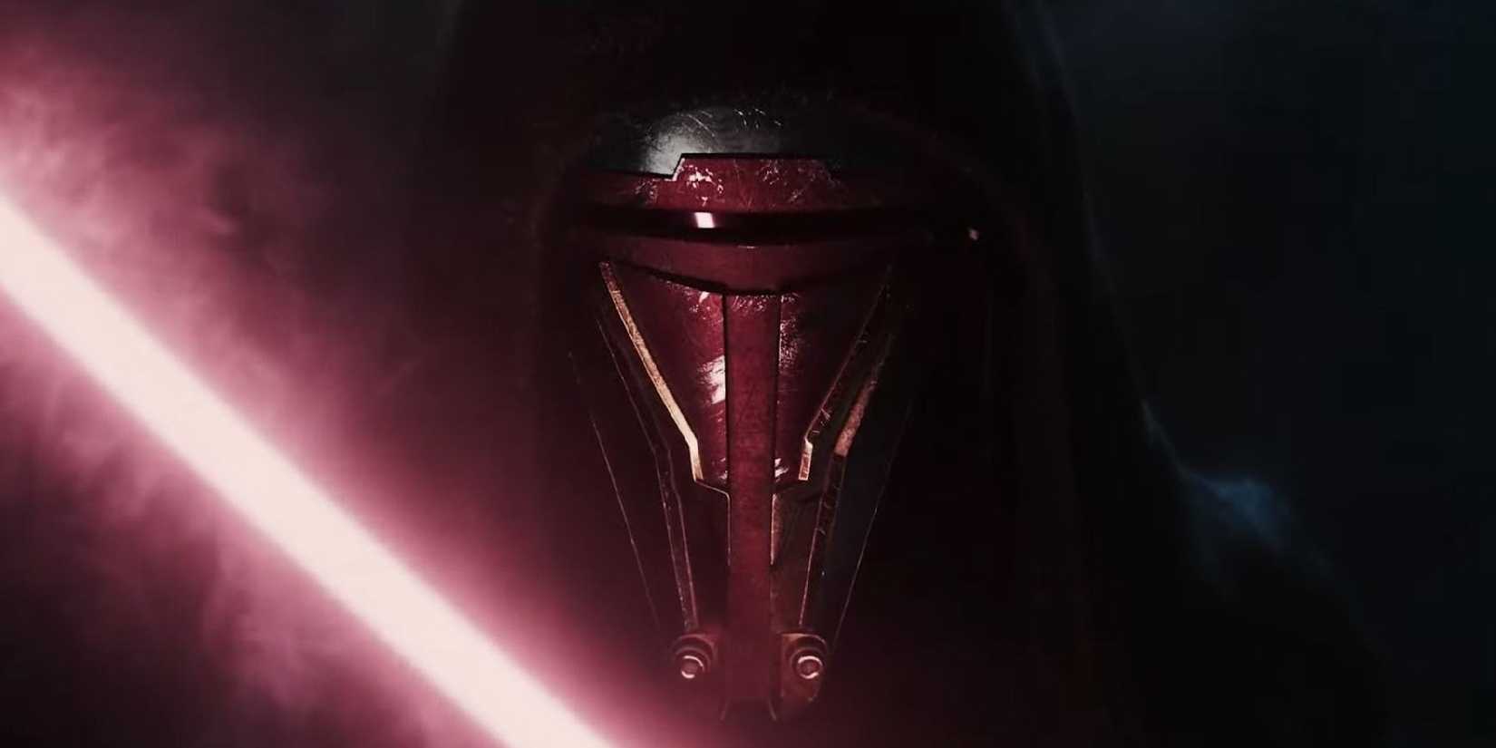 The masked and hooded Revan stands in front of a dark, smoky background with a drawn red lightsaber in promotional material for the Star Wars: Knights of the Old Republic remake.