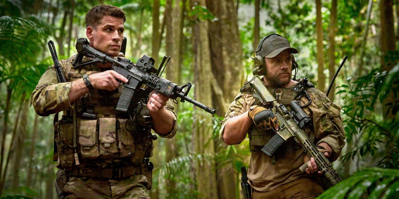 Two soldiers stalk through the woods with guns in Land of Bad