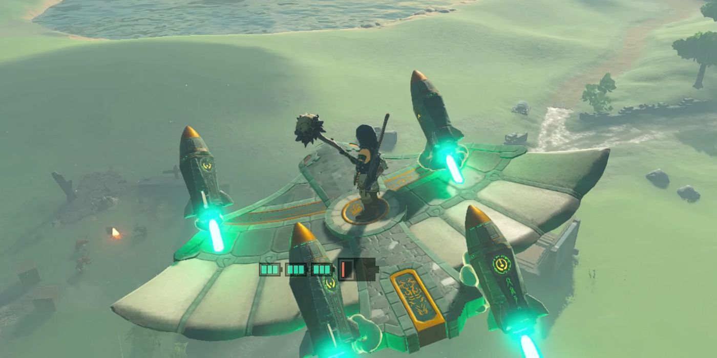 Link standing atop a Wing Glider with four Rockets attached to it, flying through the air in Tears of the Kingdom.