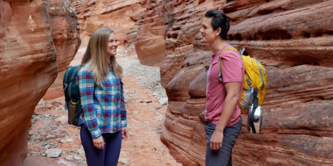 A man and woman talk among rocks in Love in Zion National