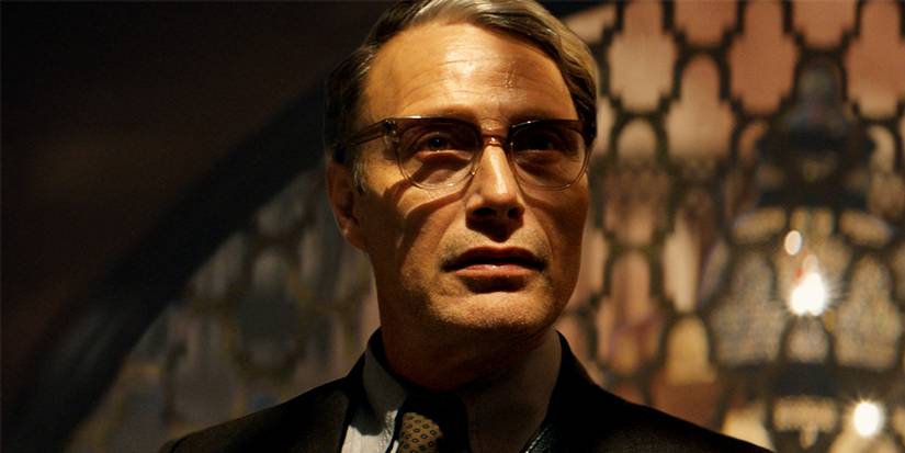 Mads Mikkelsen looking sinister in the shadows in Indiana Jones and the Dial of Destiny