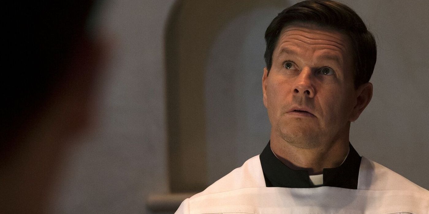 Mark Wahlberg looking in a mirror in Father Stu