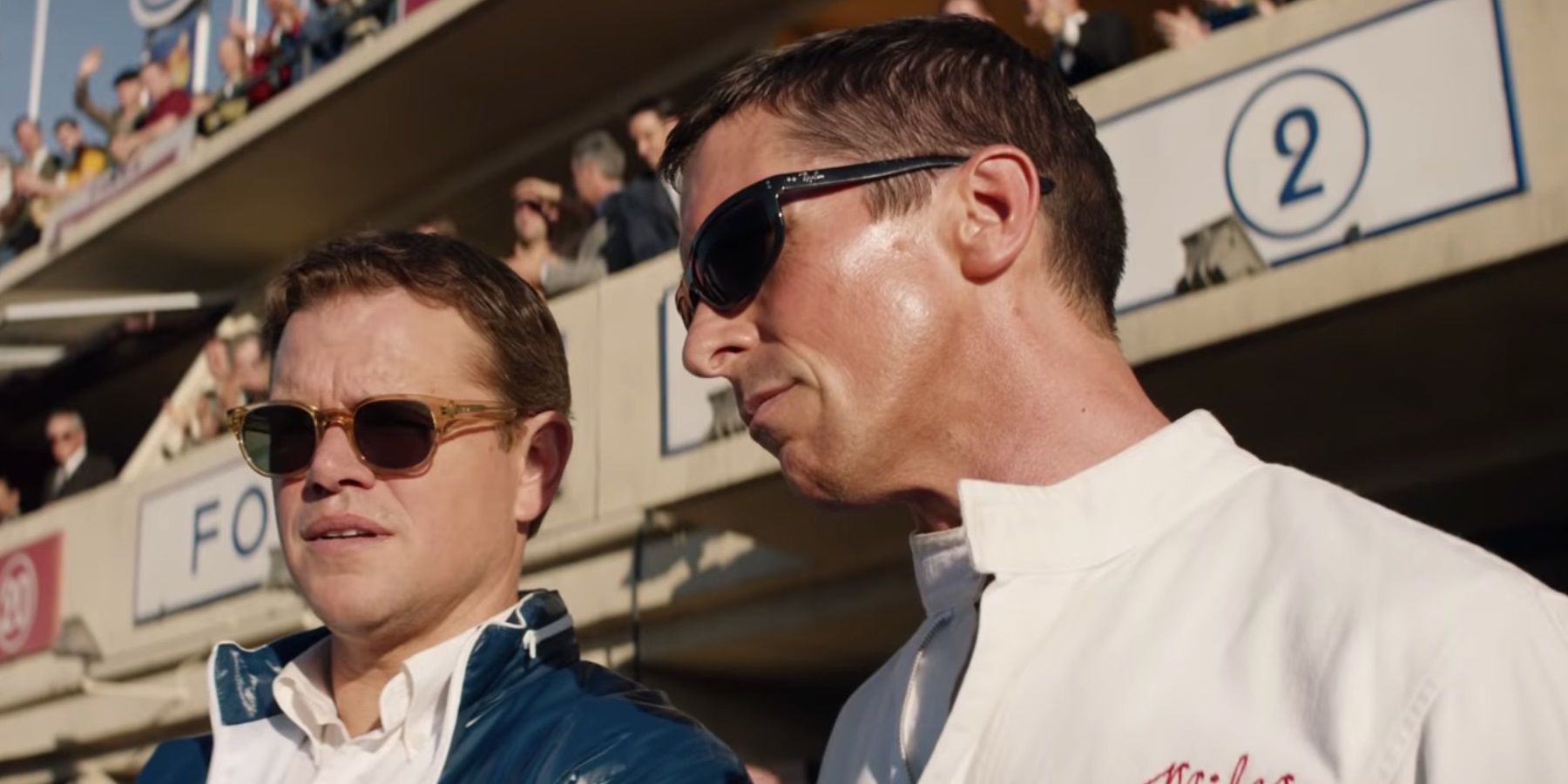 Matt Damon and Christian Bale on a racetrack in Ford v Ferrari