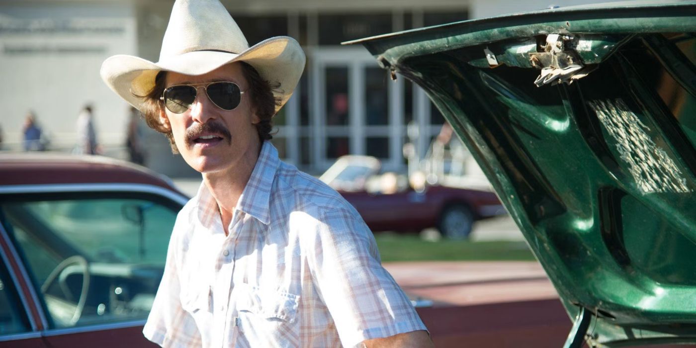 Matthew McConaughey wearing a hat and aviators looking sideways in Dallas Buyers Club