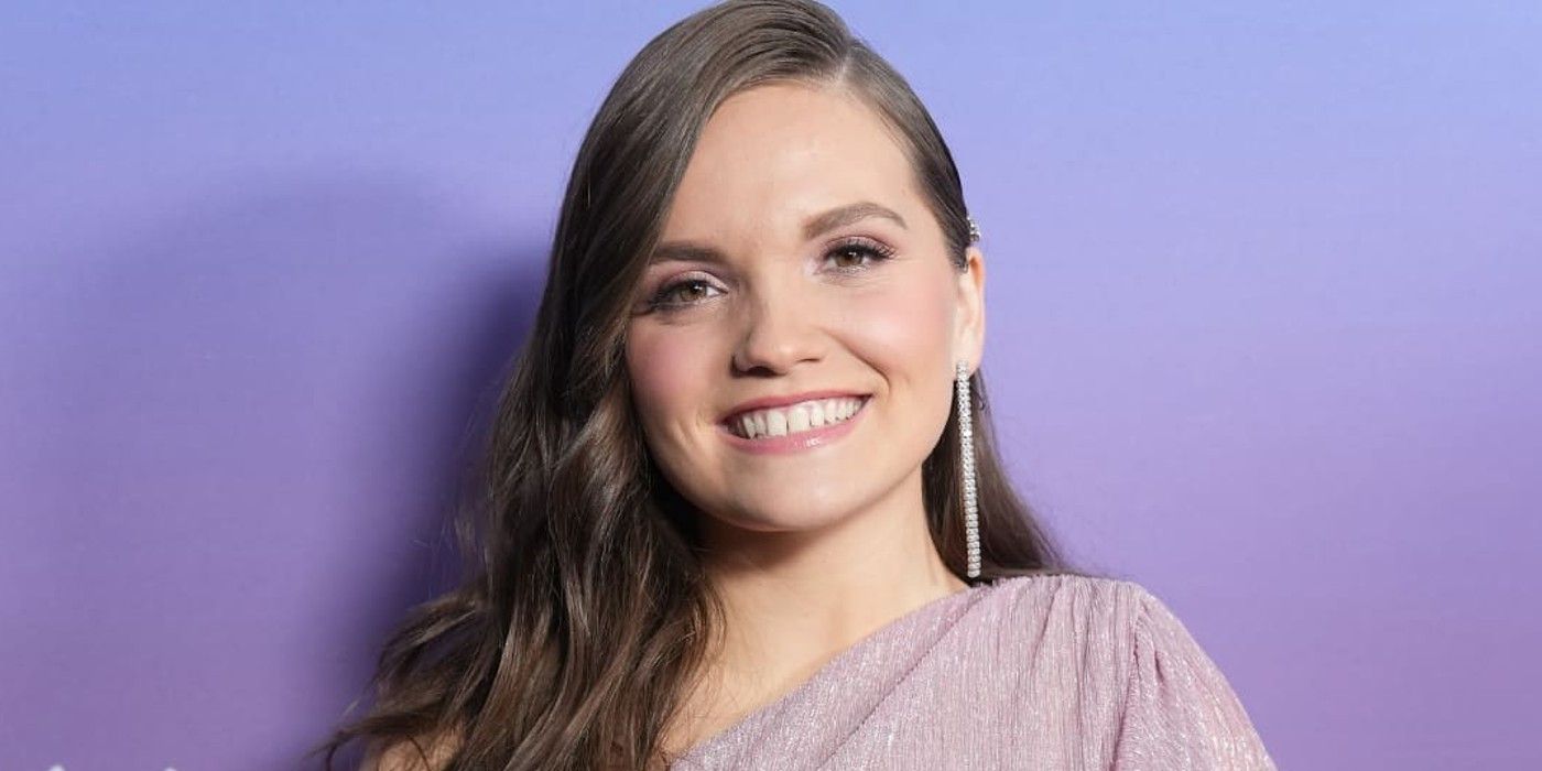 Megan Danielle from American Idol smiling with purple background