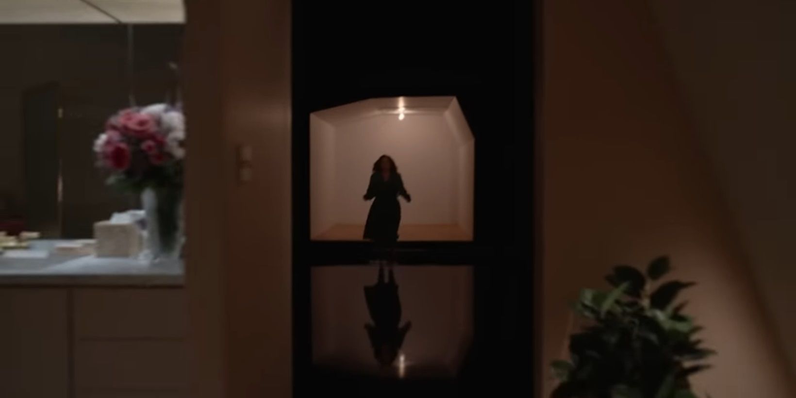 Mona in a dark hallway in Beau is Afraid