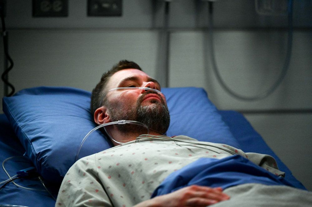 Ruzek in the hospital bed unconscious
