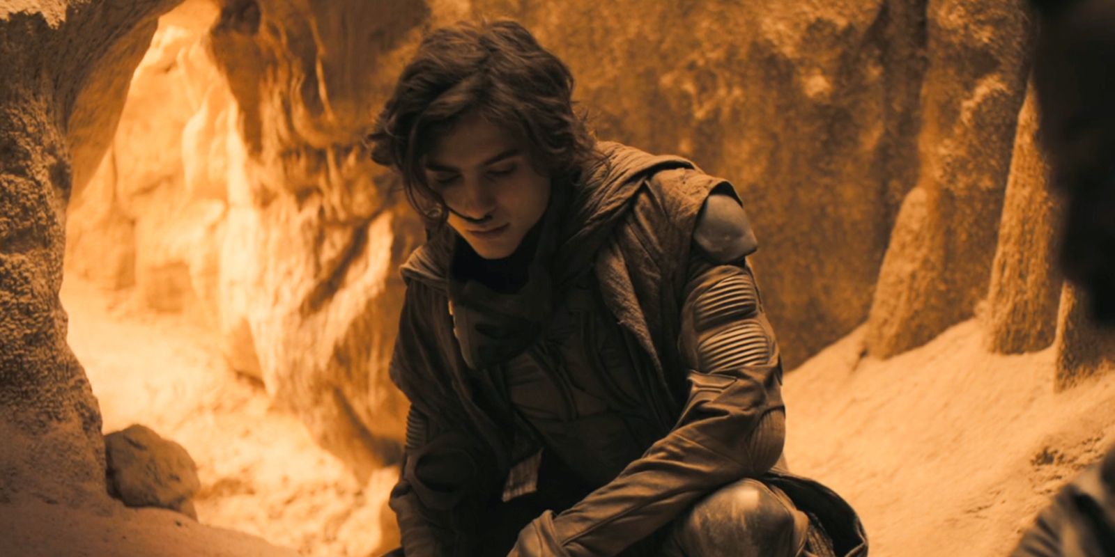 Paul kneeling in a cave in Dune