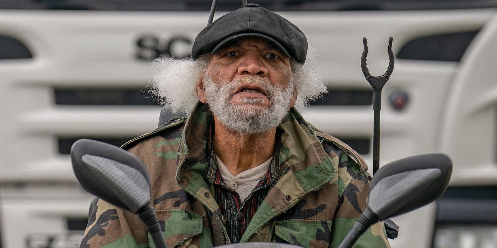 Paul Barber driving in front of a lorry in The Full Monty series