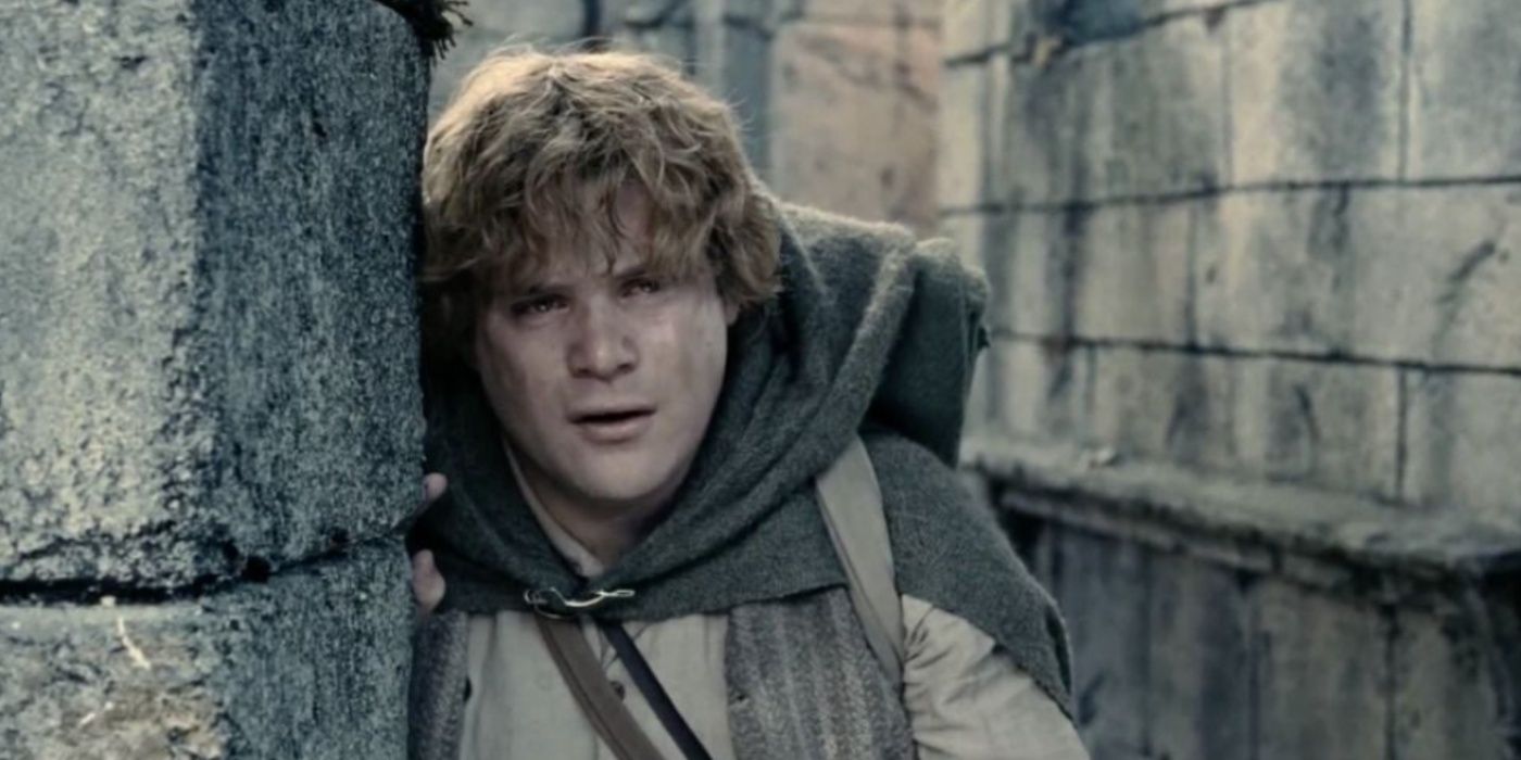 Sean Astin as Sam leans on a wall and cries in The Lord of the Rings: The Two Towers.