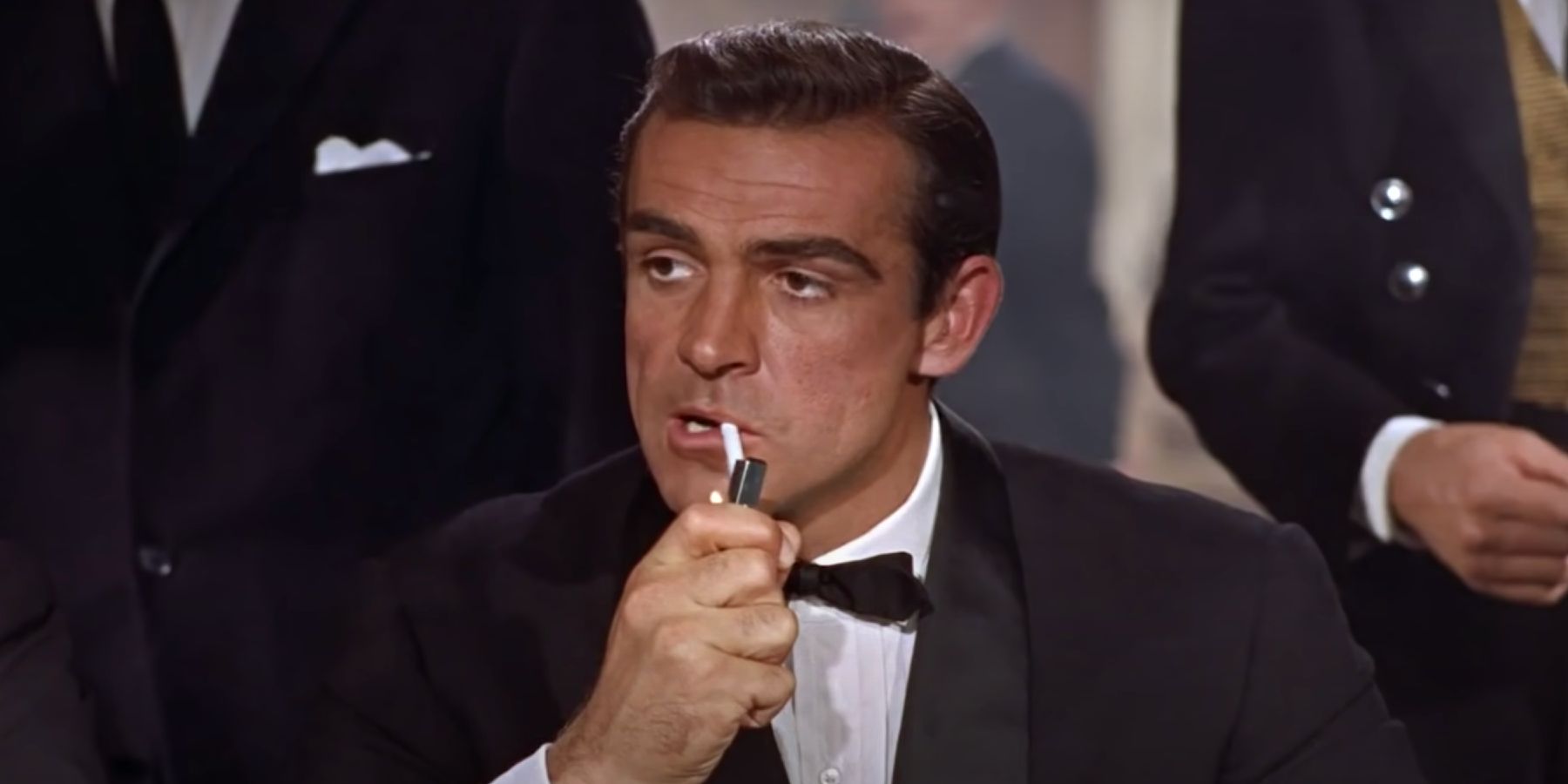 James Bond lighting his cigarette in Dr. No delivering the Bond, James Bond line