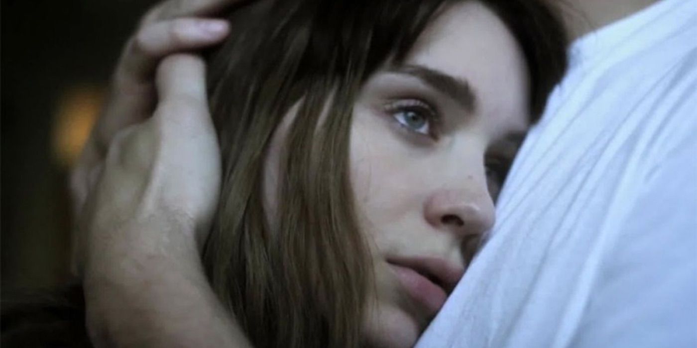 A woman looks blankly as she is held in Side Effects 