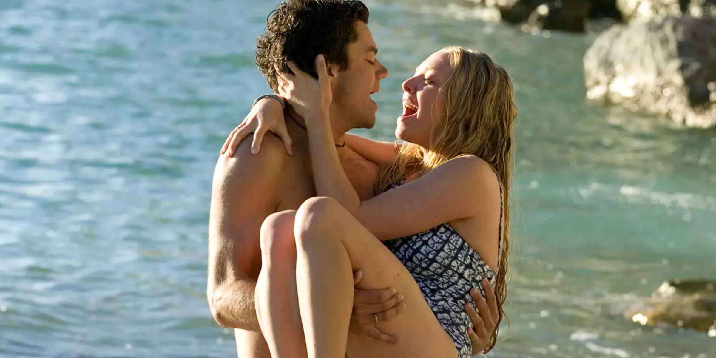 Sky and Sophie on the beach in Lay All Your Love On Me in Mamma Mia