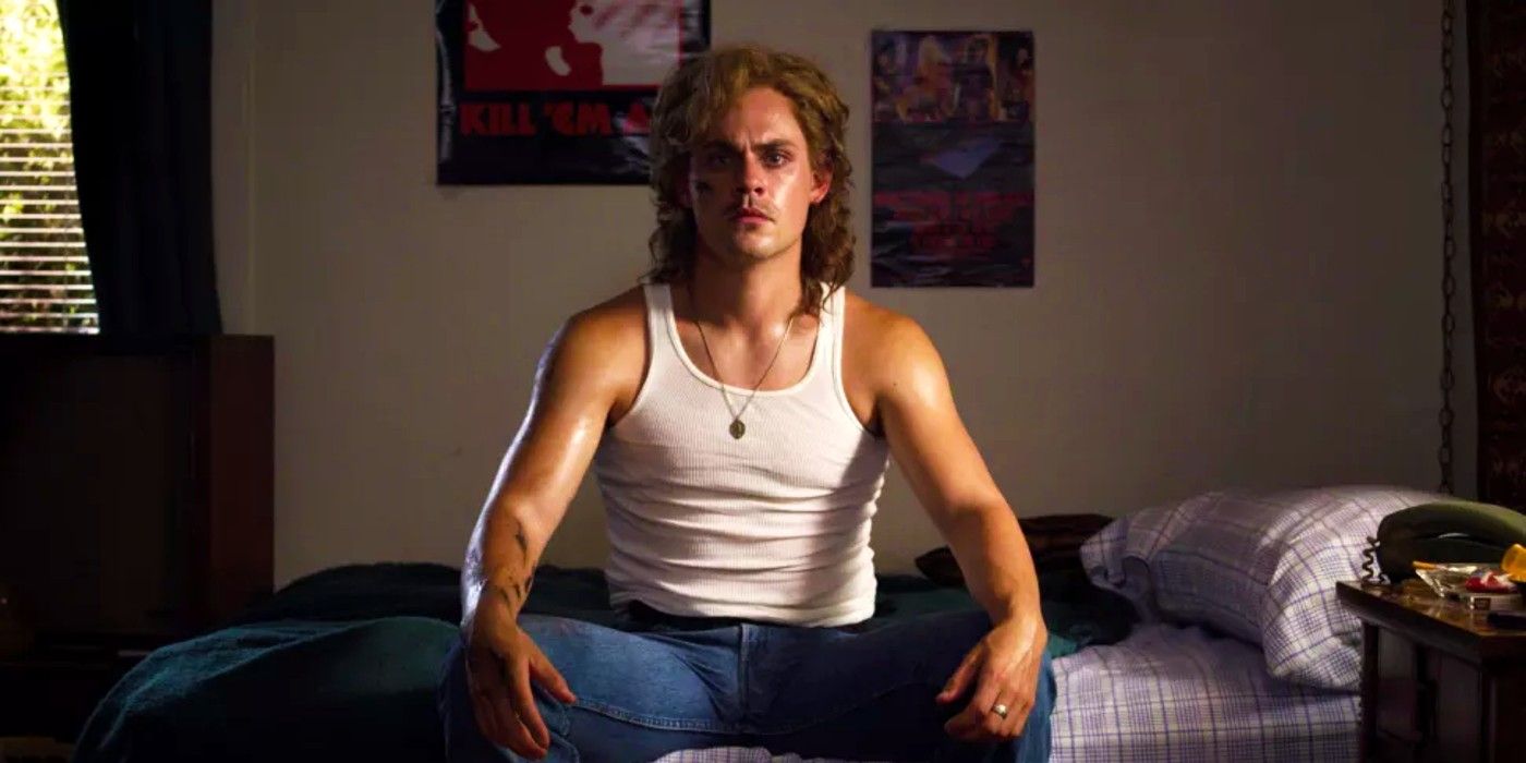 Dacre Montgomery as Billy sitting on his bed in Stranger Things