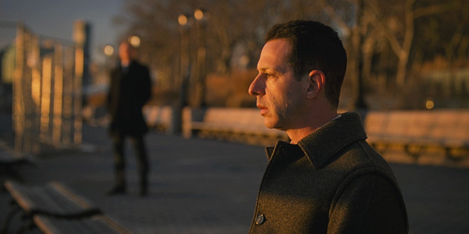 Kendall Roy (Jeremy Strong) looking at the river with Colin (Scott Nicholson) in the distance in the Succession Series Finale 