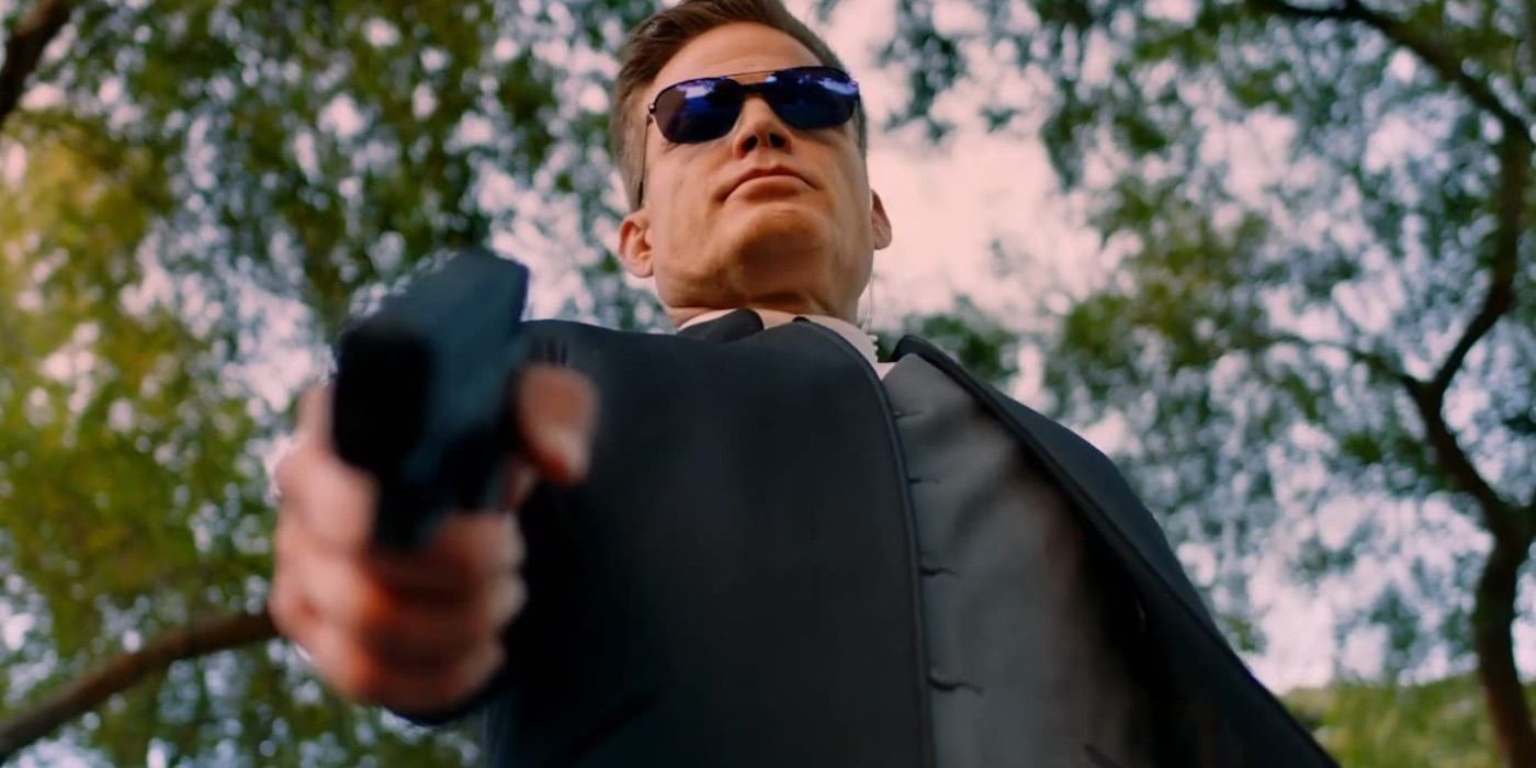 A man points a pistol while wearing sunglasses in The 2nd