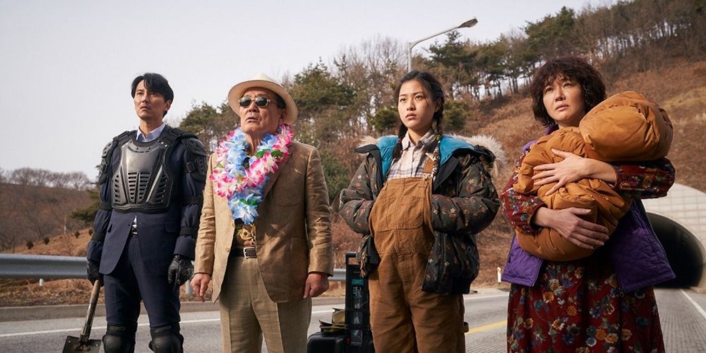 the cast of The Odd Family standing on a road