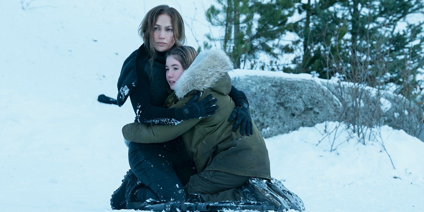 Zoe (Lucy Paez) and the Mother (Jennifer Lopez) embrace in the snow in The Mother 