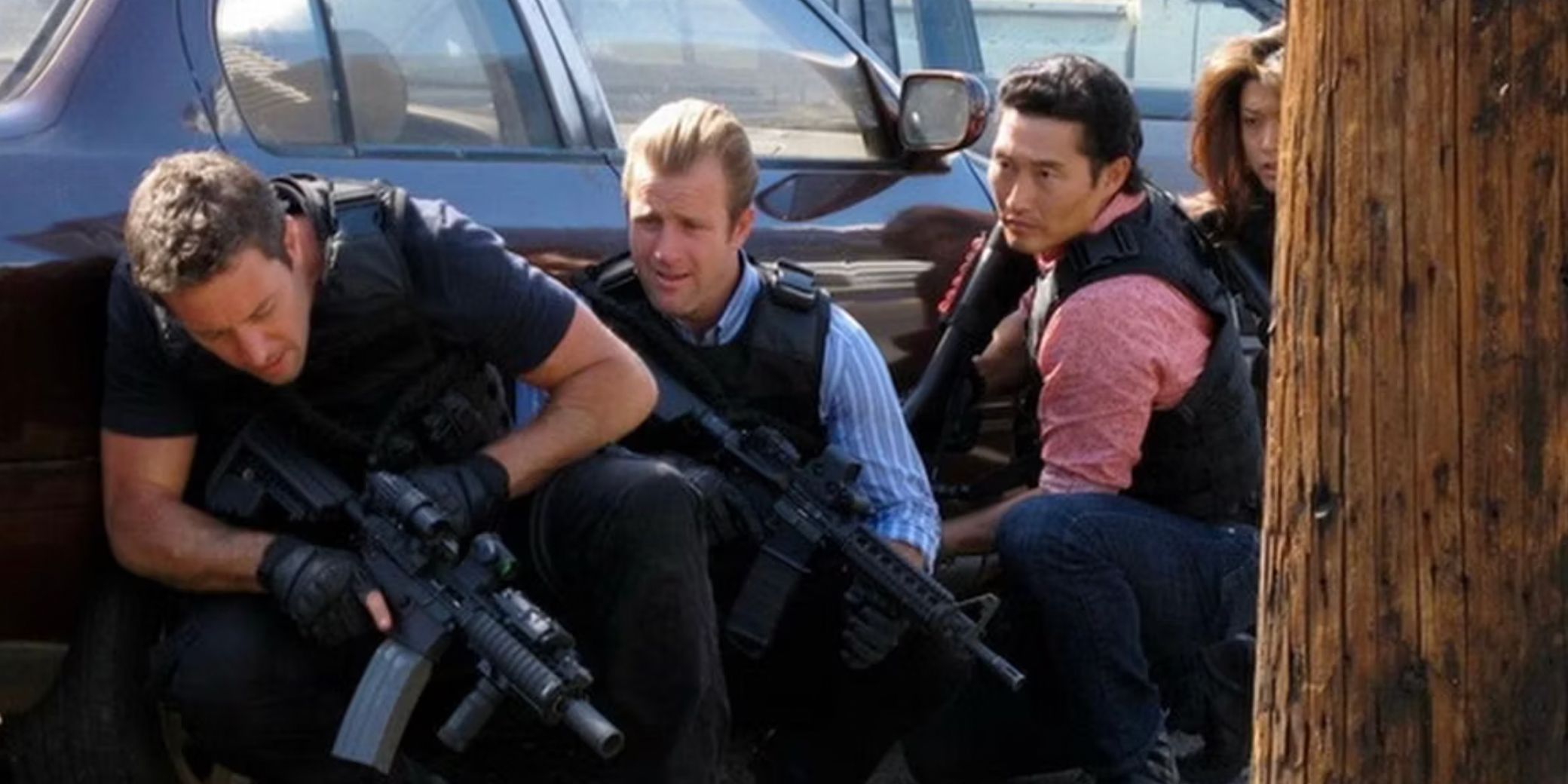 The team ducks behind a car with their weapons in Hawaii Five-0 episode Ua Hala