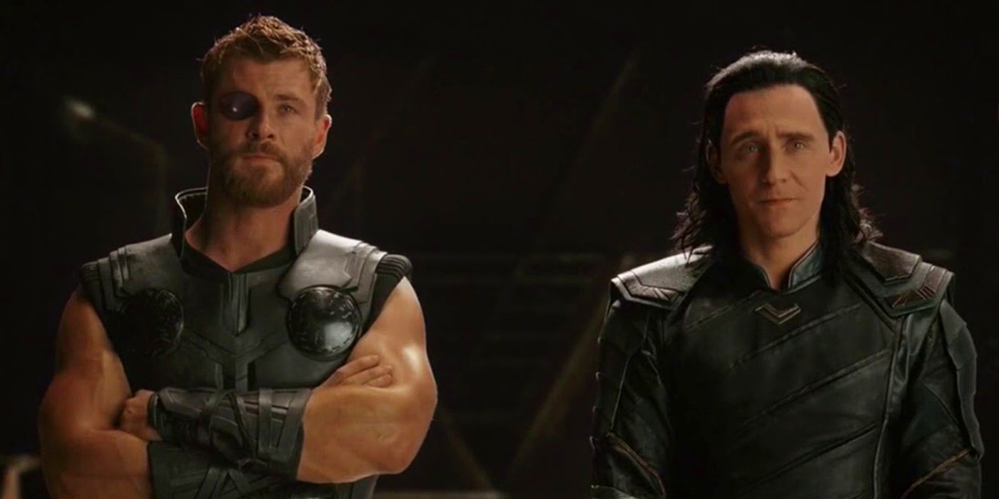 Thor (Chris Hemsworth) and Loki (Tom Hiddleston) stand next to each other in Thor: Ragnarok