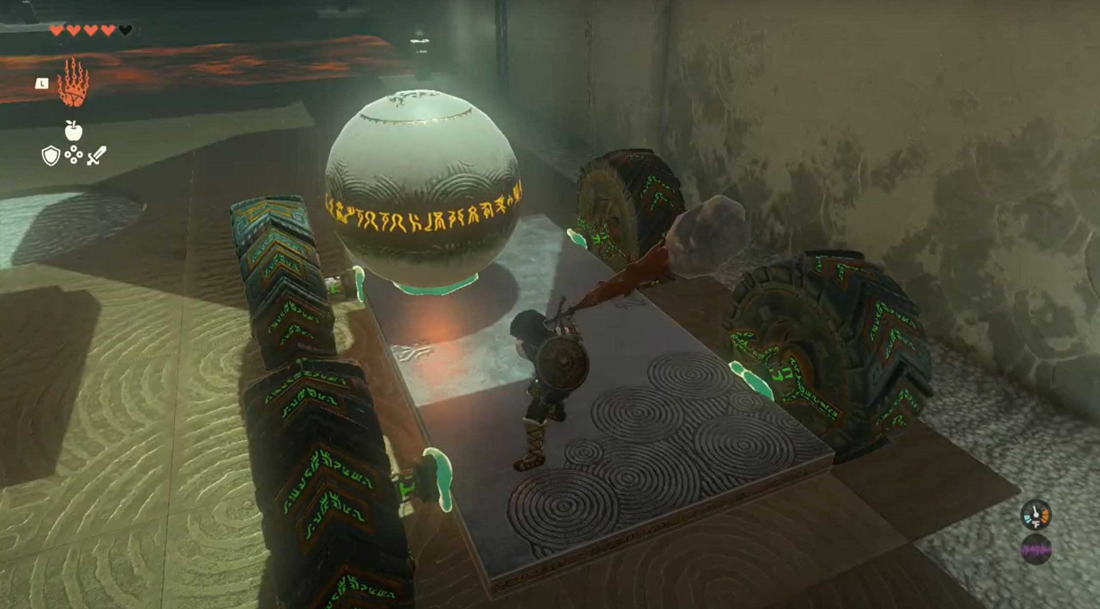 Link prepares to hit the wheels of a large cart with a ball attached.