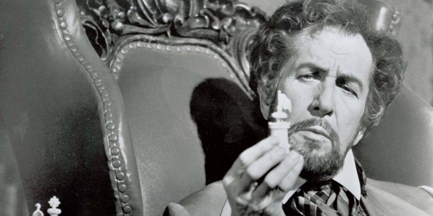 Vincent Price holding a chess piece in An Evening With Edgar Allen Poe